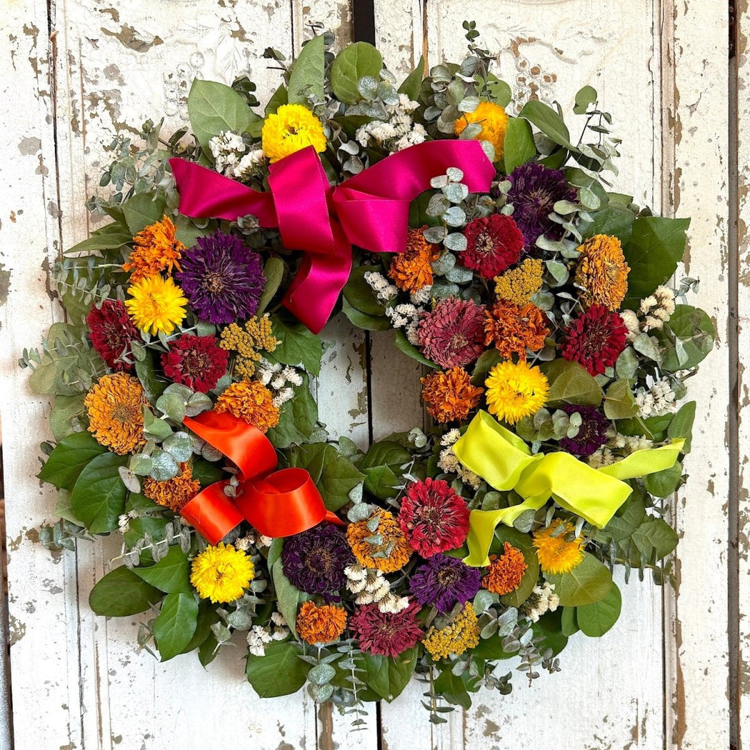 Marigolds and Zinnias Celebration Wreath - Creekside Farms Bright and bold dried marigolds and zinnias on fragrant fresh eucalyptus and salal wreath 18"/22"