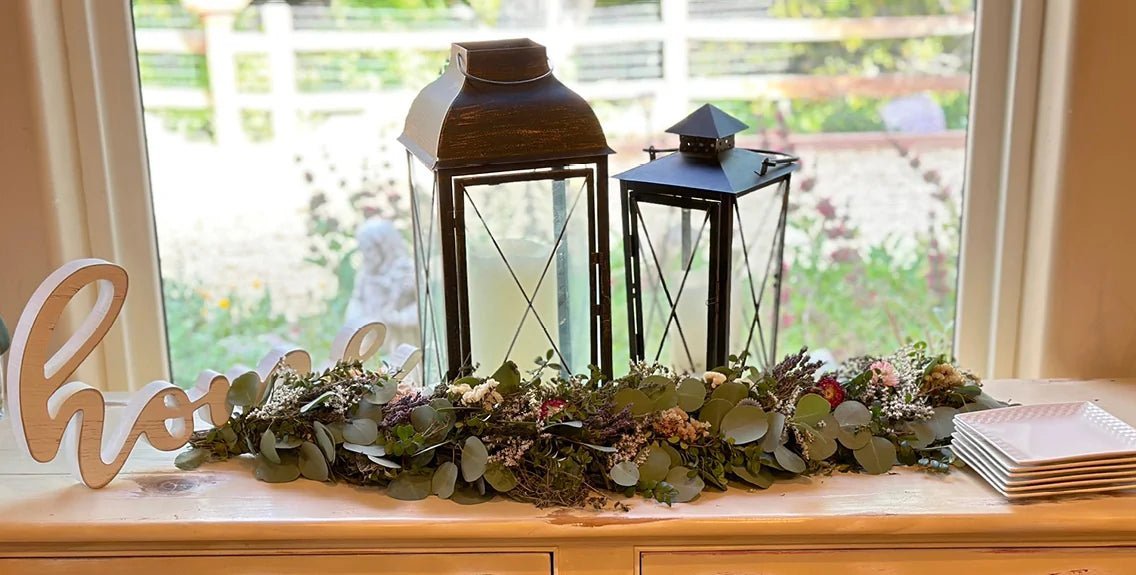 Mantle by window with lanterns and leaves