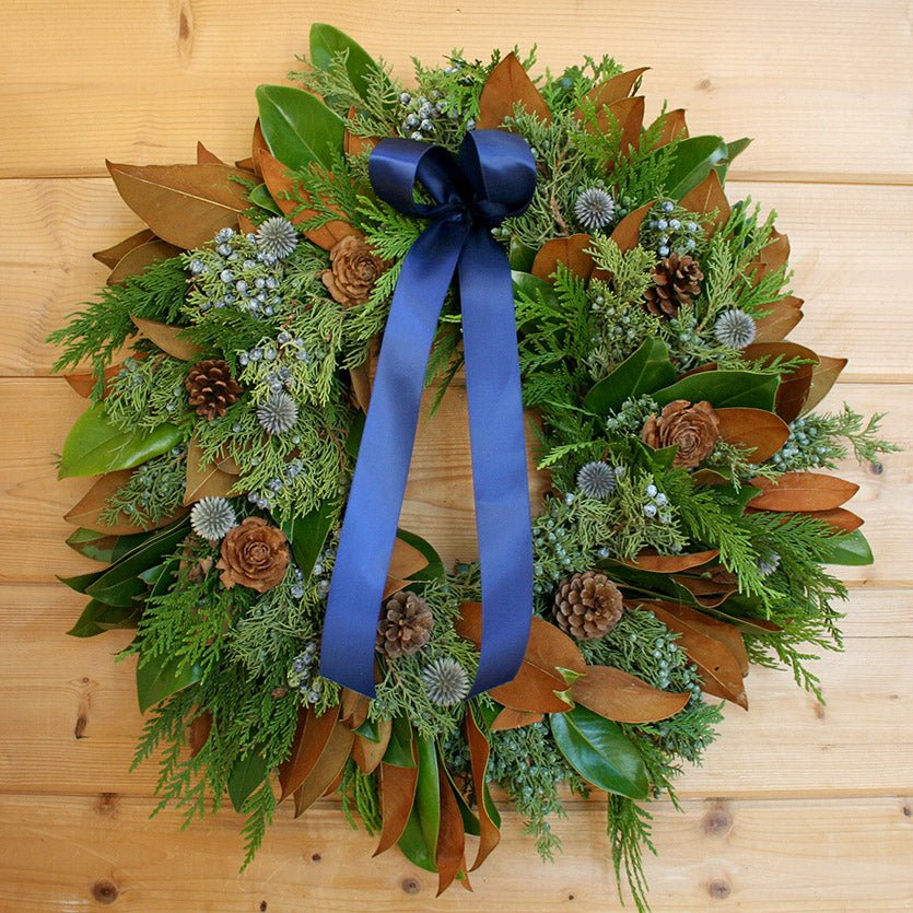 Blue Winter Wreath - Creekside Farms Fresh Magnolia & juniper with cedar flower cones, blue thistle, pine cones and blue ribbon wreath 22"