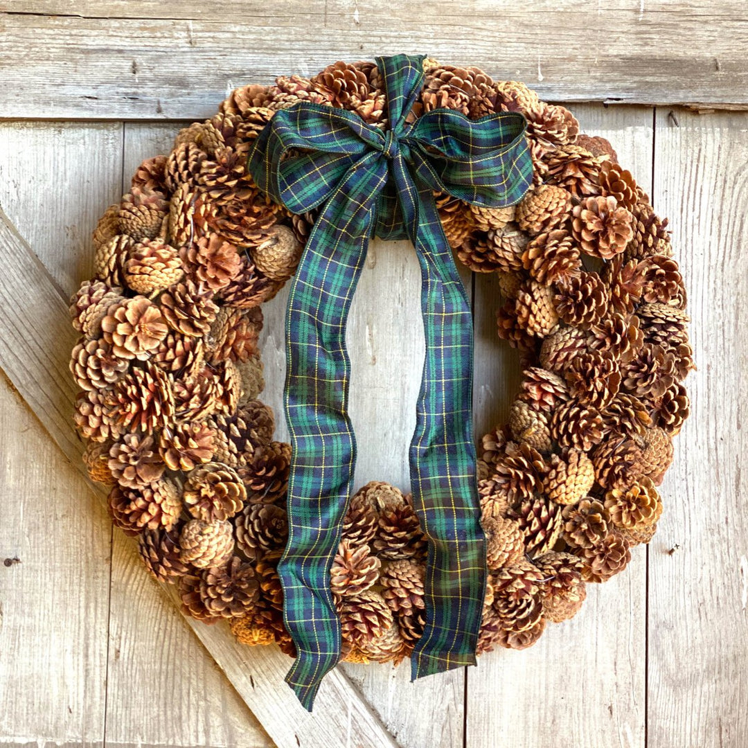 Pine Cone Wreath - Creekside Farms Made with an abundance of pine cones with tartan plaid wired bow wreath 24"