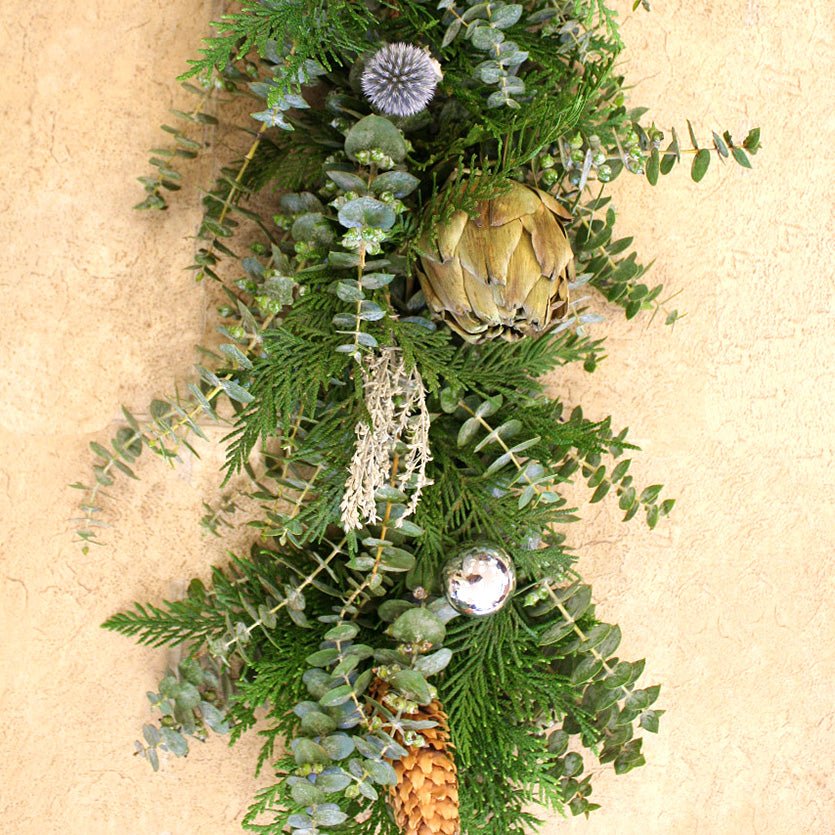 Winter Artichoke Garland 6' - Creekside Farms A fragrant combination of fresh eucalyptus, featuring dried artichokes, artemisia, blue thistles, pine cones and silver ornaments garland 6'